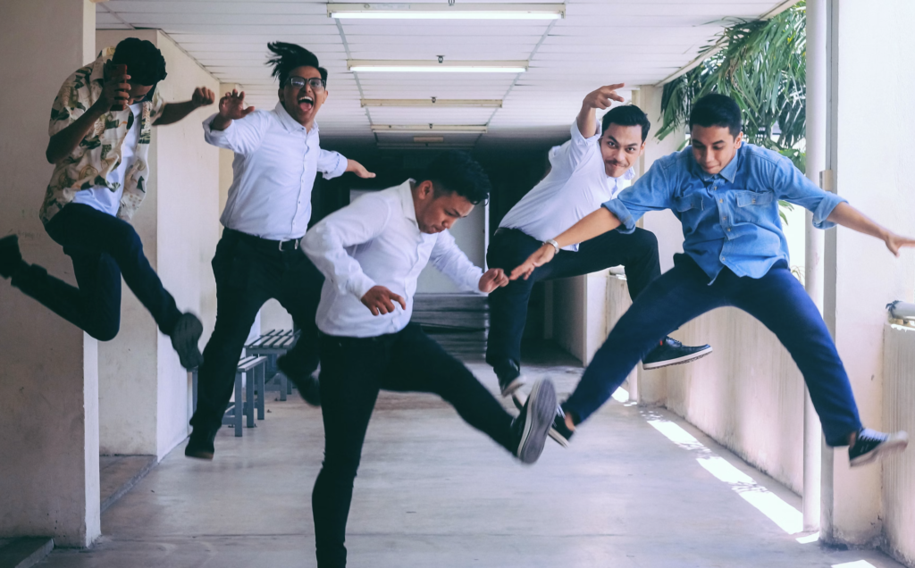 Group of 5 students jumping for joy